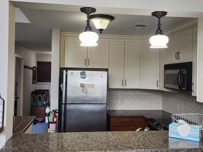 1 Pine Crescent, Unit 23 Vernon, NJ 07462 - Photo 8 of 28 a kitchen with stainless steel appliances granite countertop a refrigerator a stove and a sink