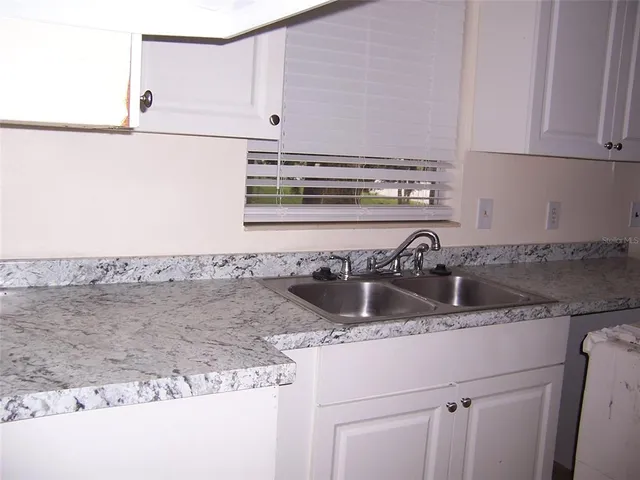 a kitchen with a sink and cabinets
