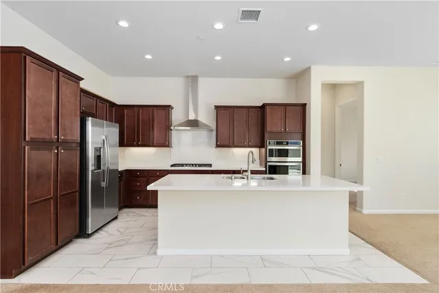 a large kitchen with stainless steel appliances