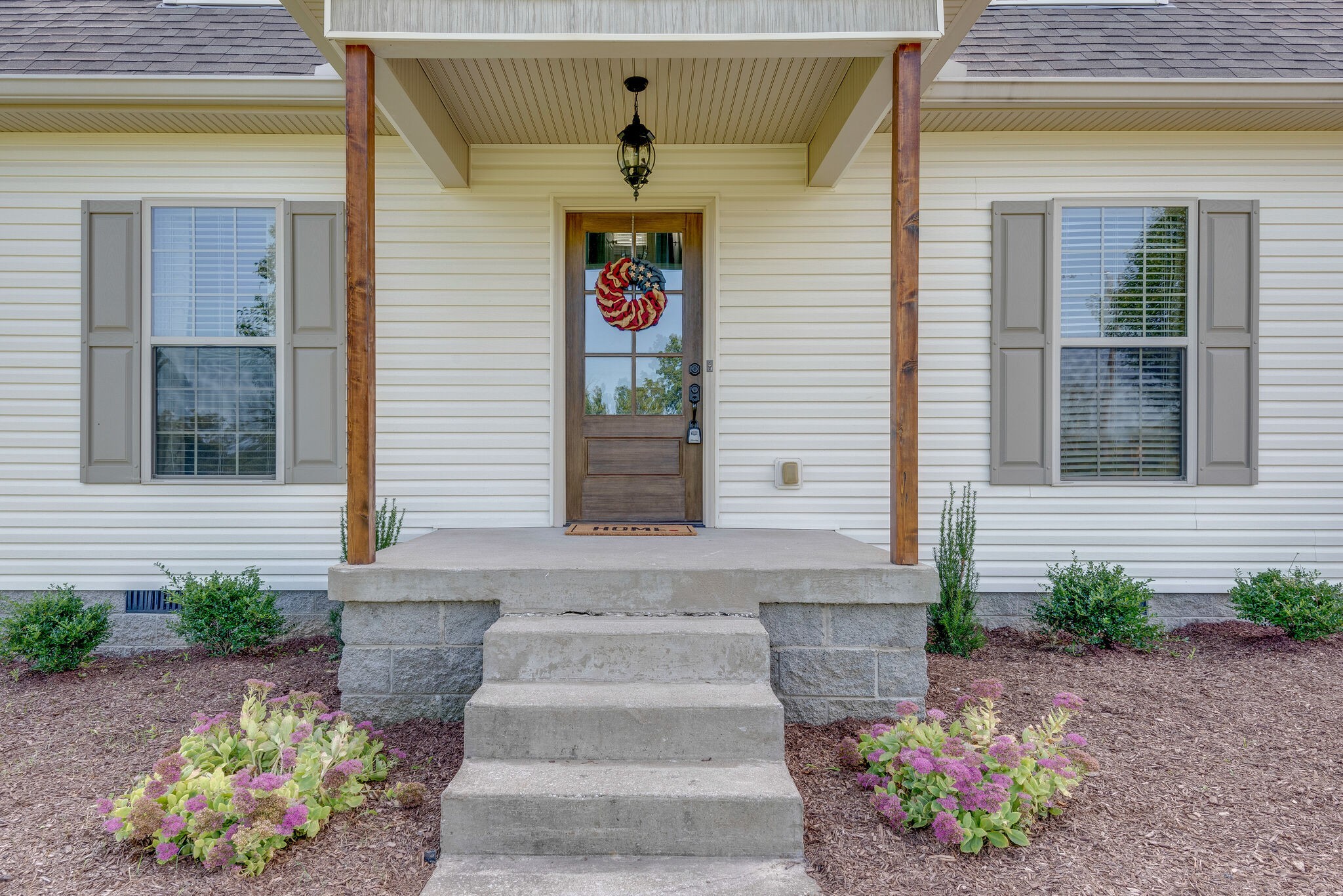 994 Hoover Road Burns, TN 37029 - Photo 2 of 28 a front view of a house with a garden
