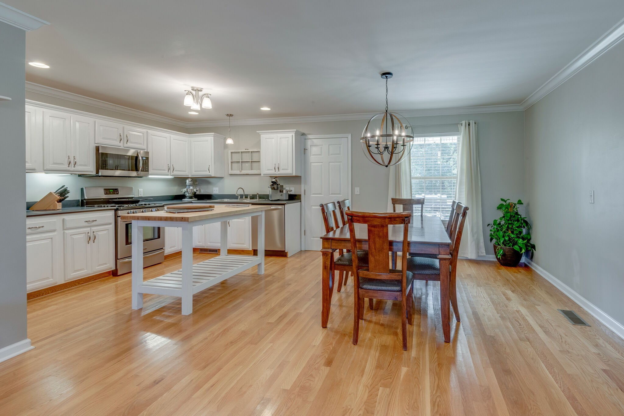 994 Hoover Road Burns, TN 37029 - Photo 12 of 28 a dining room filled chandelier and wooden floor