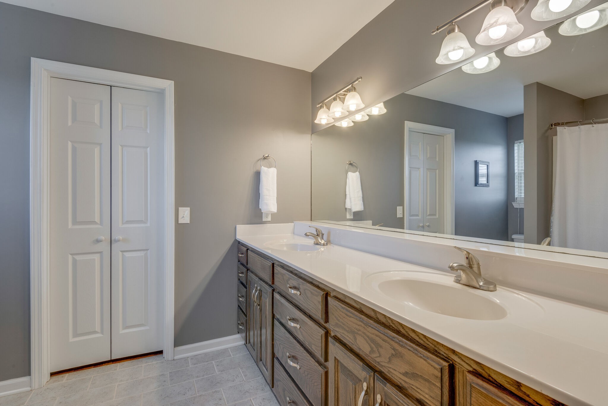 994 Hoover Road Burns, TN 37029 - Photo 18 of 28 a bathroom with a double vanity sink and a mirror