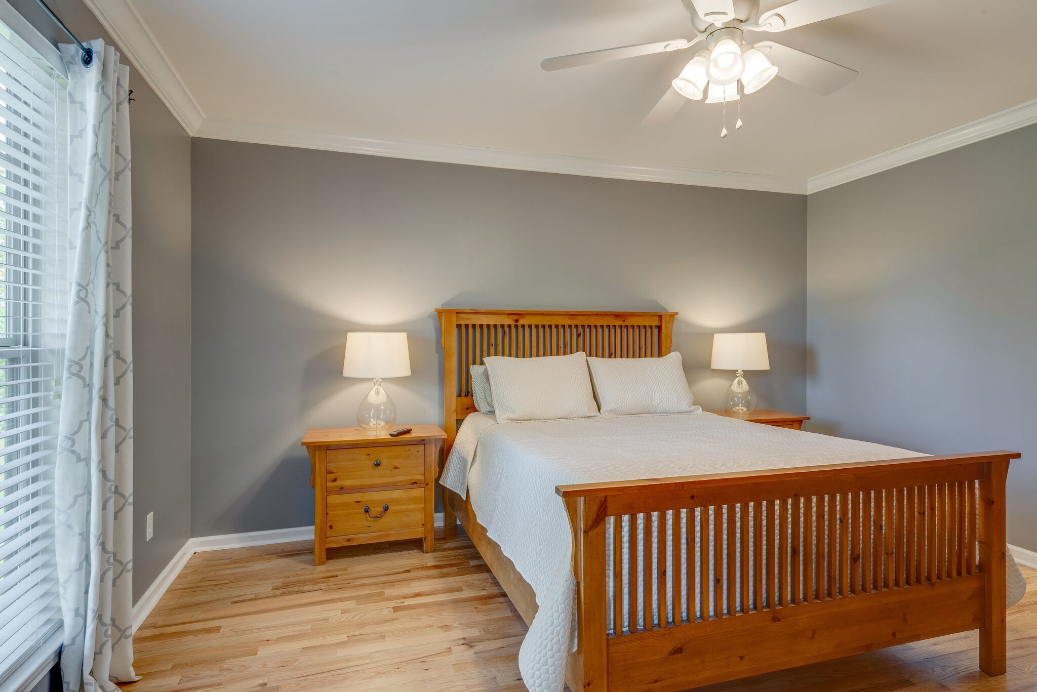 994 Hoover Road Burns, TN 37029 - Photo 19 of 28 a bedroom with a bed and a chandelier