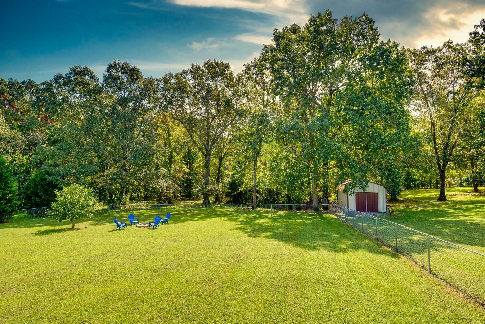 994 Hoover Road Burns, TN 37029 - Photo 3 of 28 a view of a swimming pool and trees in the background