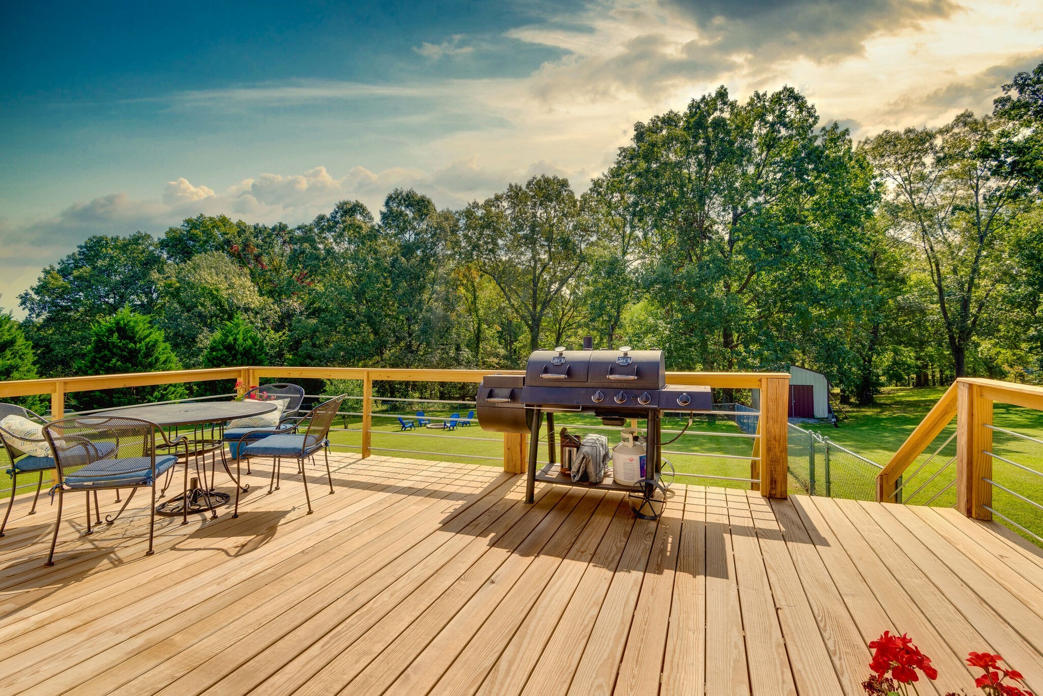 994 Hoover Road Burns, TN 37029 - Photo 4 of 28 a view of a chairs and table on the wooden deck