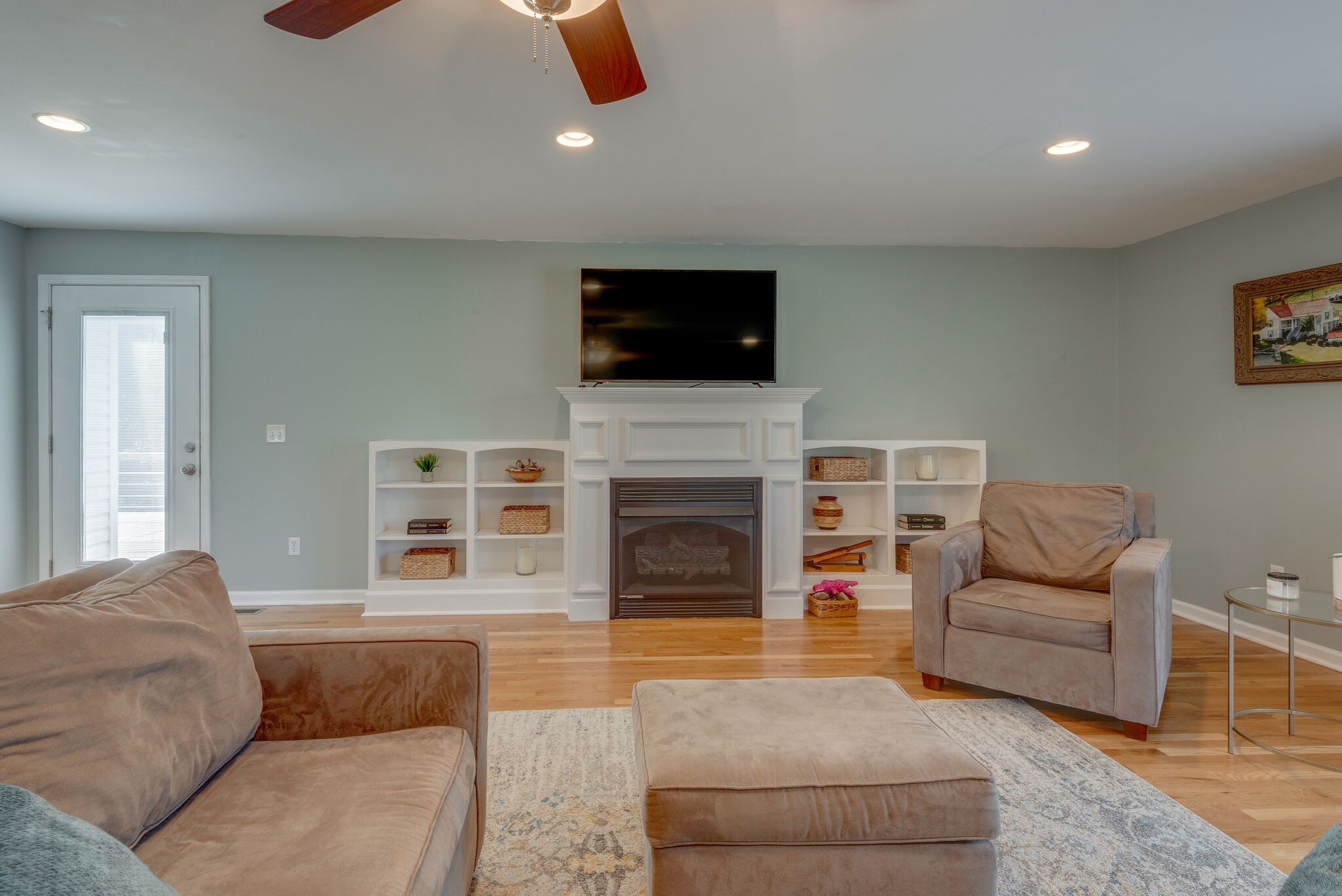 994 Hoover Road Burns, TN 37029 - Photo 6 of 28 a living room with furniture a flat screen tv and a fireplace
