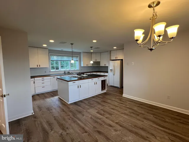 a kitchen that has a sink stainless steel appliances a counter space and a window