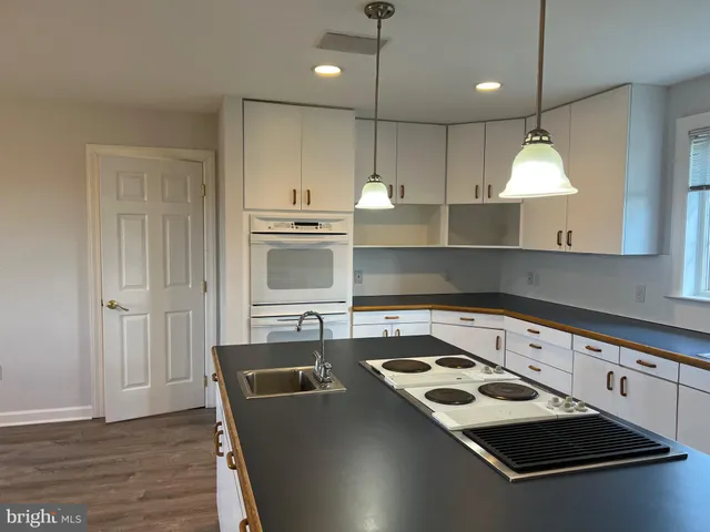 a view of bathroom with a sink and a mirror