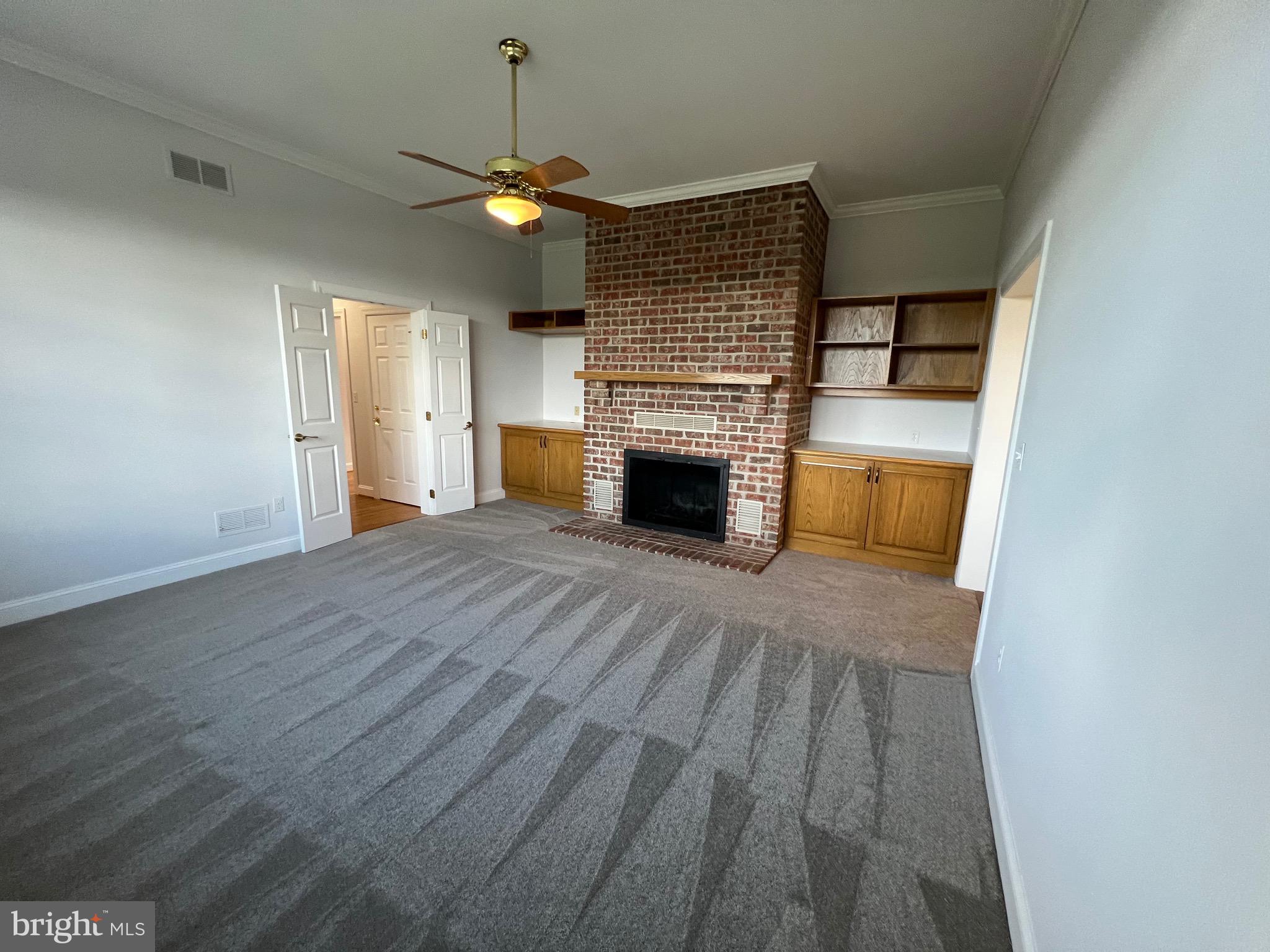 1343 Phoenix Road Sparks Glencoe, MD 21152 - Photo 19 of 57 an empty room with wooden floor fireplace and windows
