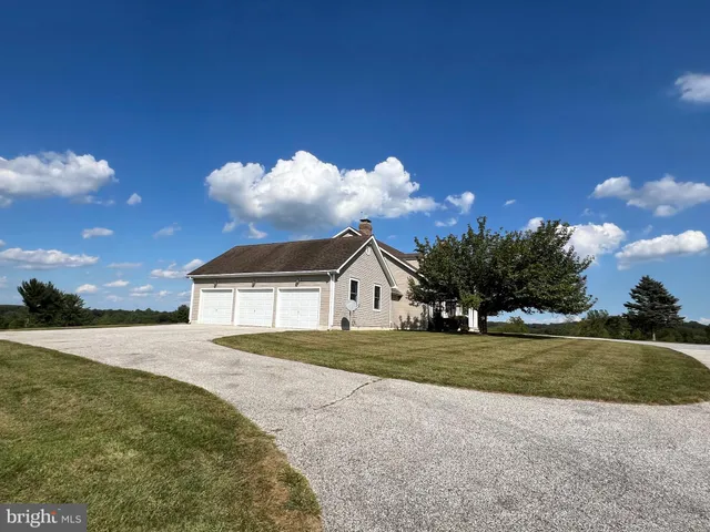 a front view of a house with a garden and plants