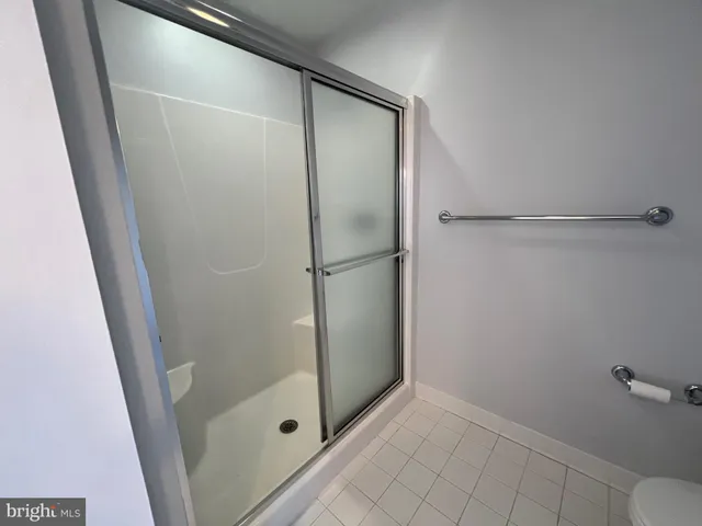 en empty room with wooden floor and windows