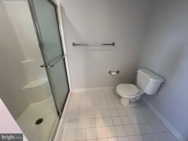 a spacious bathroom with a double vanity sink toilet mirror and window