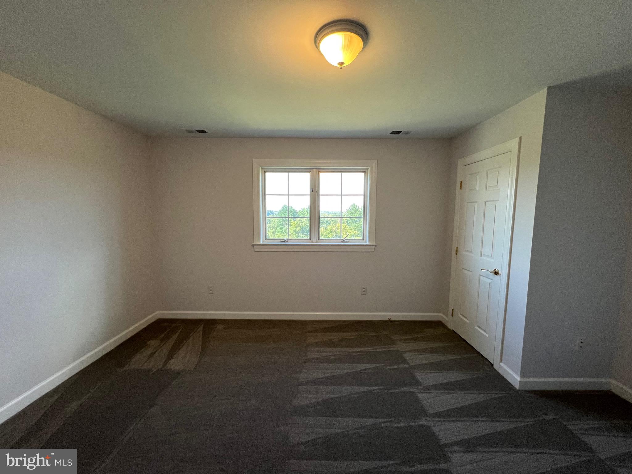 1343 Phoenix Road Sparks Glencoe, MD 21152 - Photo 44 of 57 an empty room with wooden floor and windows