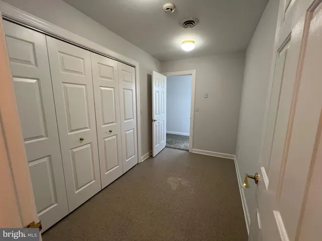a view of walk in closet with clothes