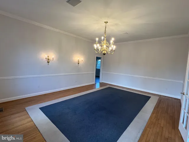 a kitchen with stainless steel appliances granite countertop a stove a sink dishwasher and a refrigerator with wooden floor