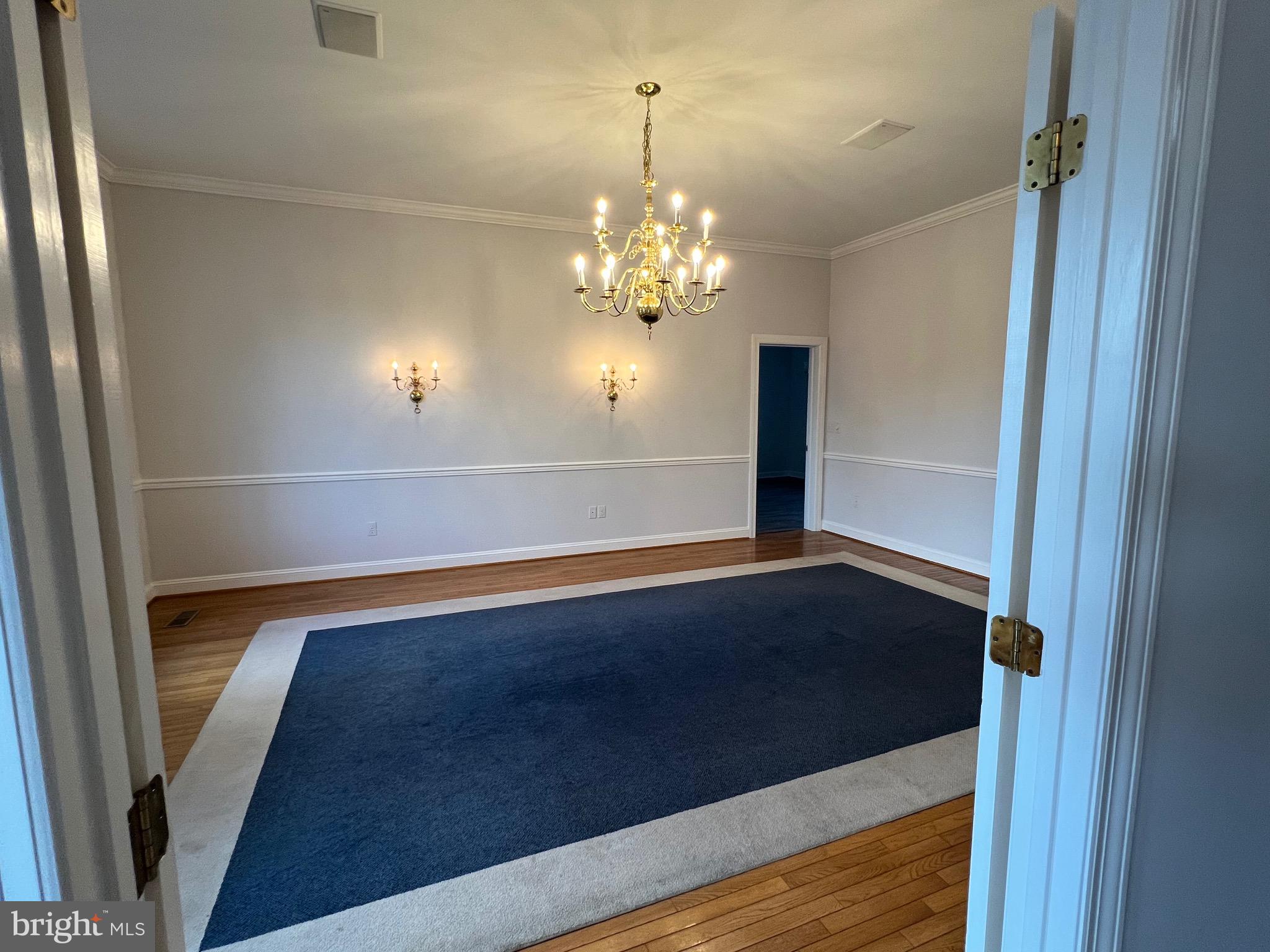 1343 Phoenix Road Sparks Glencoe, MD 21152 - Photo 10 of 57 a view of a chandelier in big room with wooden floor