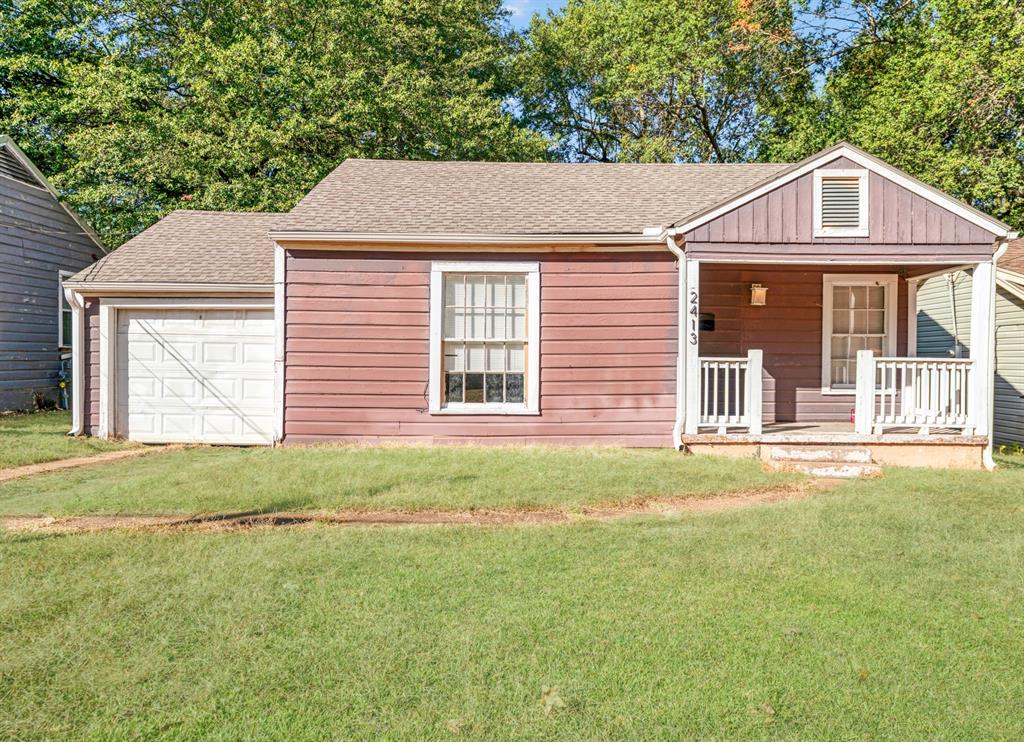 2413 Simpson Street Paris, TX 75460 - Photo 1 of 15 a front view of a house with a garden