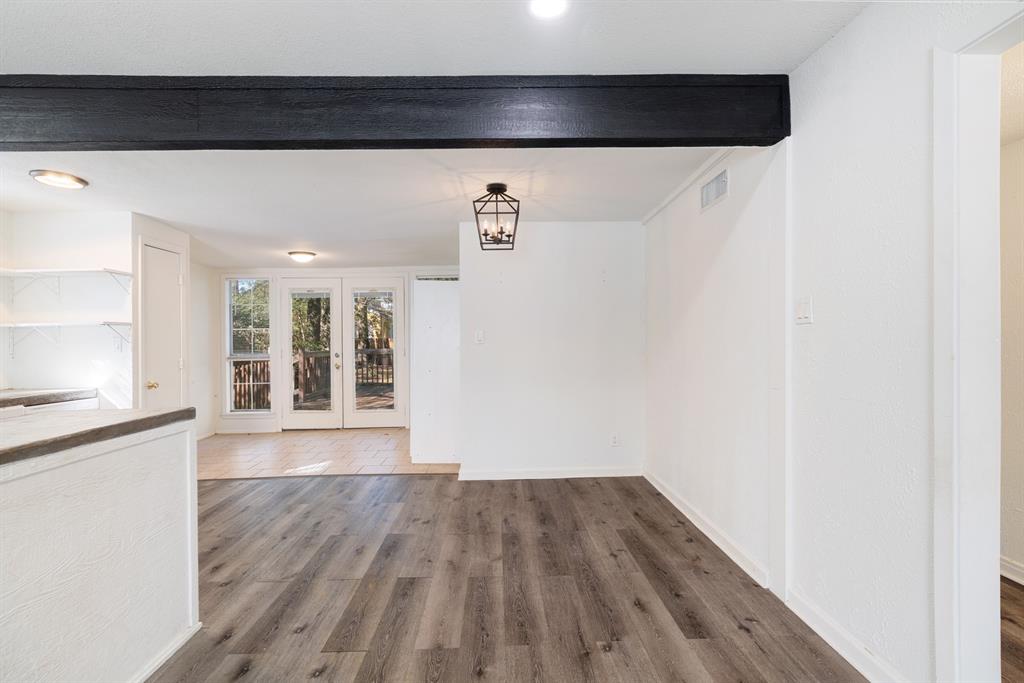 2413 Simpson Street Paris, TX 75460 - Photo 11 of 15 a view of an empty room with wooden floor and a window