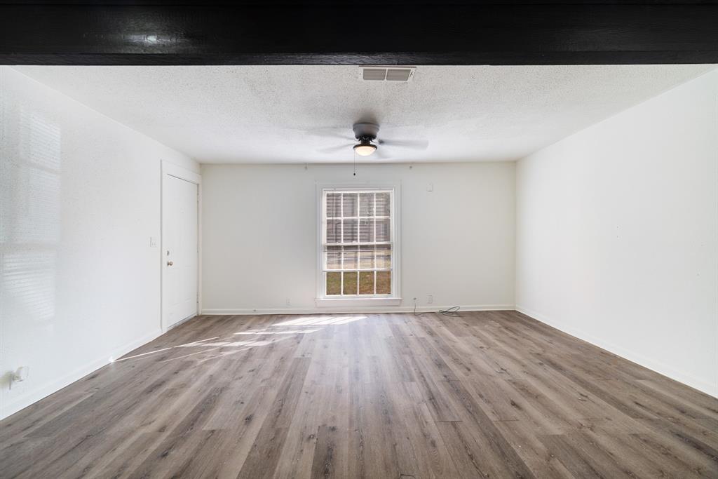 2413 Simpson Street Paris, TX 75460 - Photo 5 of 15 a view of an empty room with wooden floor and a window