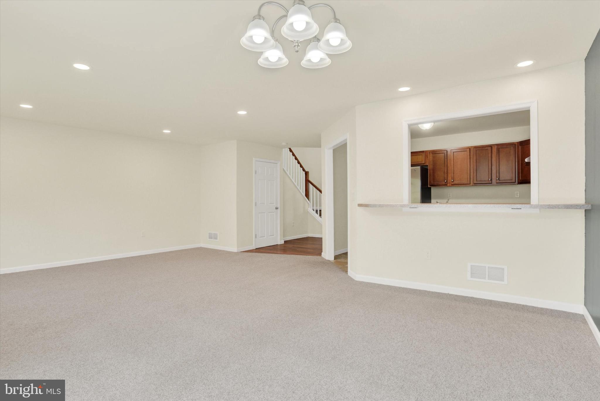 48 Dustin Drive Halifax, PA 17032 - Photo 3 of 31 an empty room with a fireplace and a chandelier fan