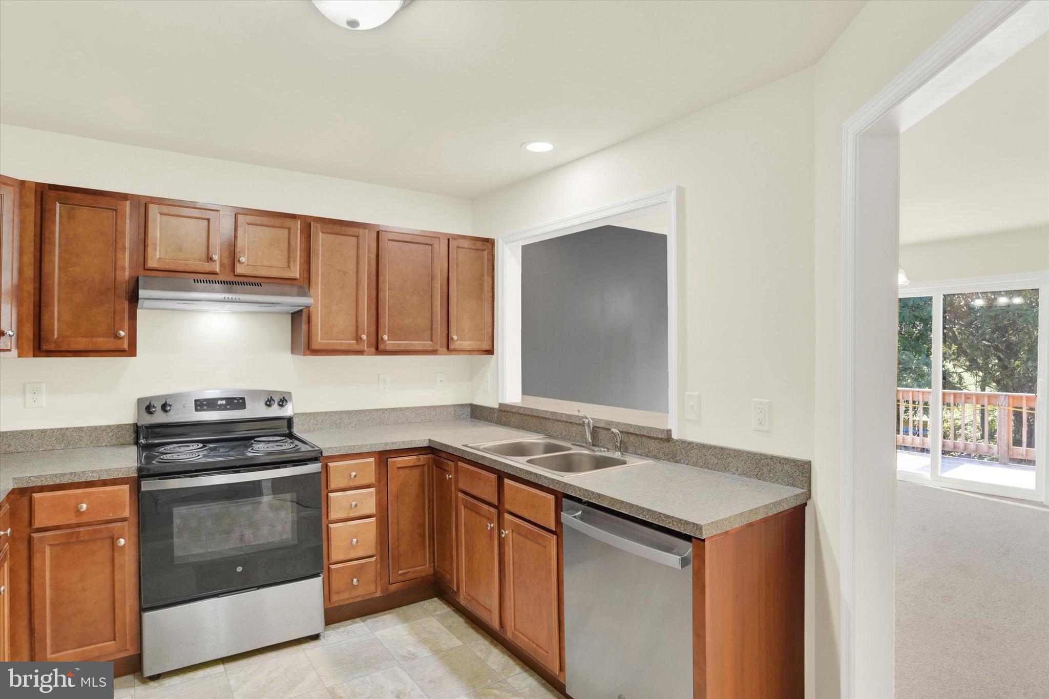 48 Dustin Drive Halifax, PA 17032 - Photo 7 of 31 a kitchen with granite countertop a sink stove and cabinets