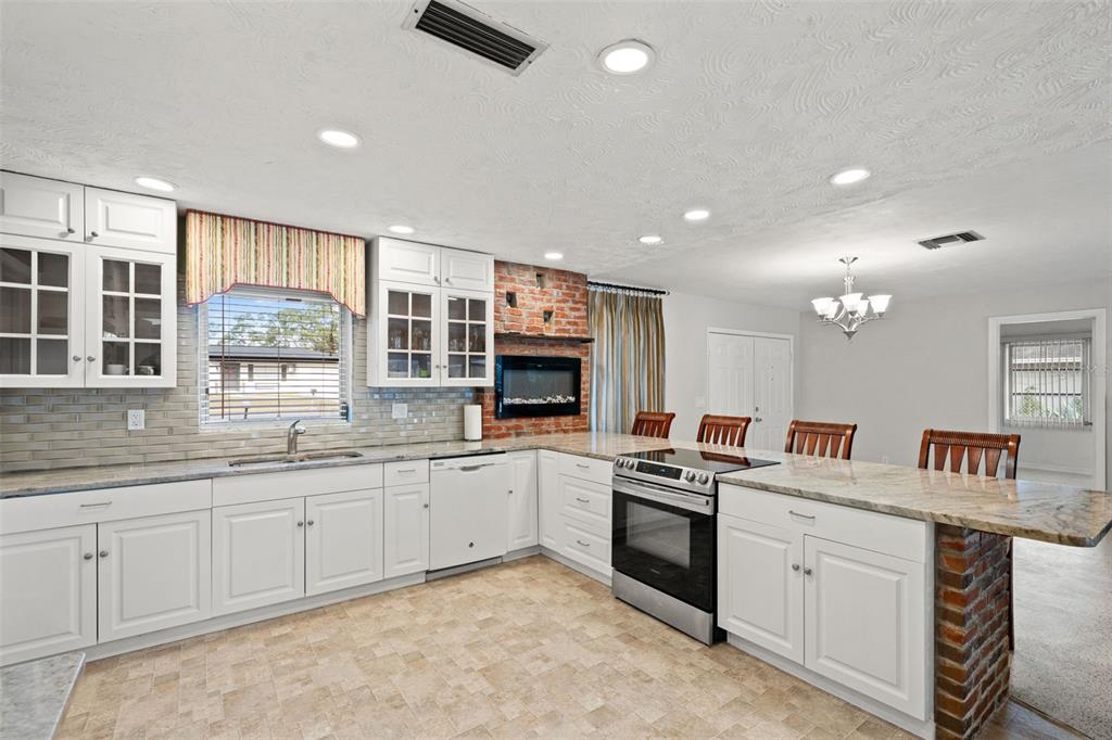 6422 Fairlawn Street Spring Hill, FL 34606 - Photo 11 of 43 a kitchen with white cabinets and sink