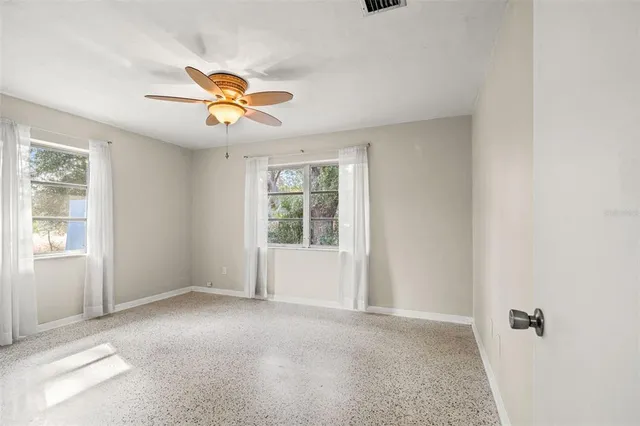 a view of a livingroom with a ceiling fan and window