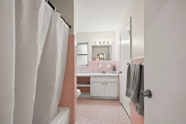 a bathroom with a sink a mirror and a shower
