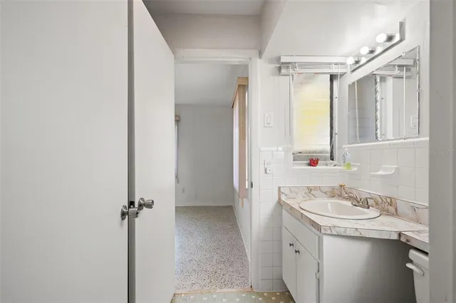 a bathroom with a sink a mirror and a bathtub