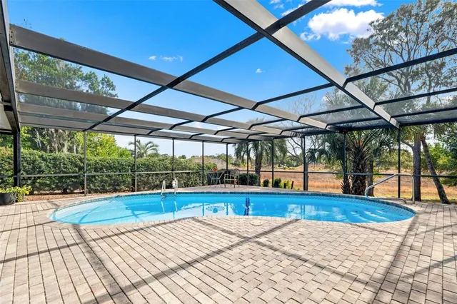 a view of pool with a patio