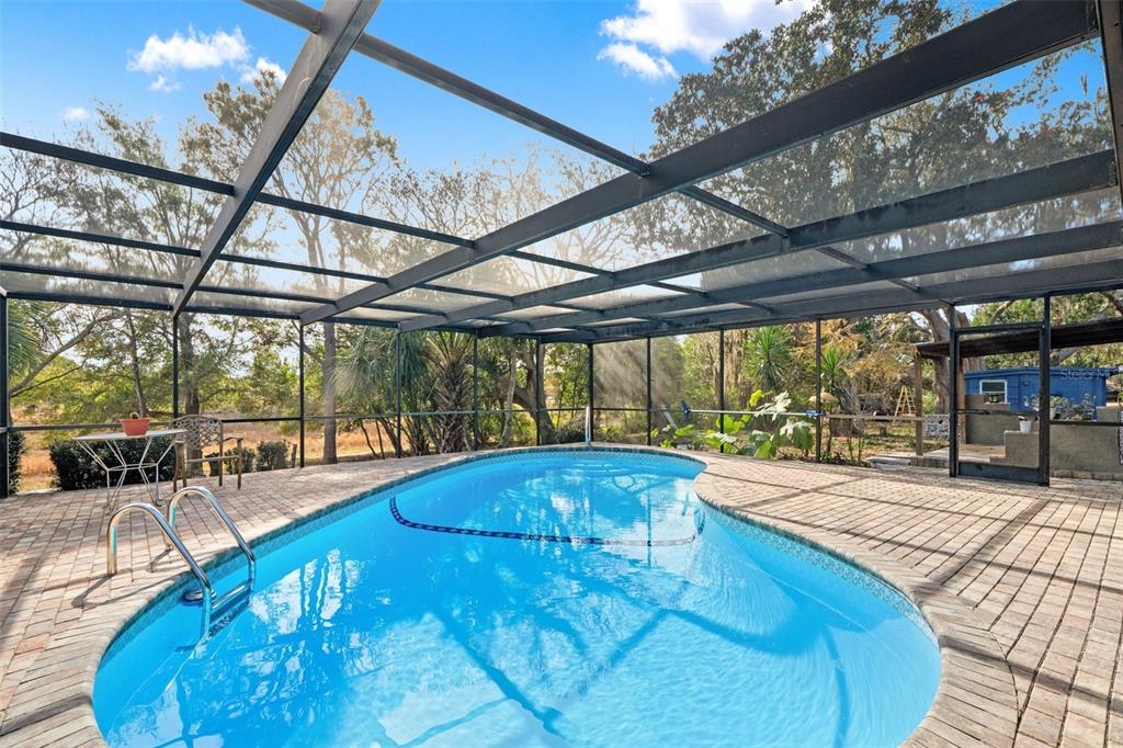 6422 Fairlawn Street Spring Hill, FL 34606 - Photo 28 of 43 a view of a swimming pool with a patio
