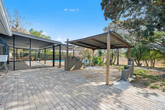a view of a patio with a table and chairs under an umbrella