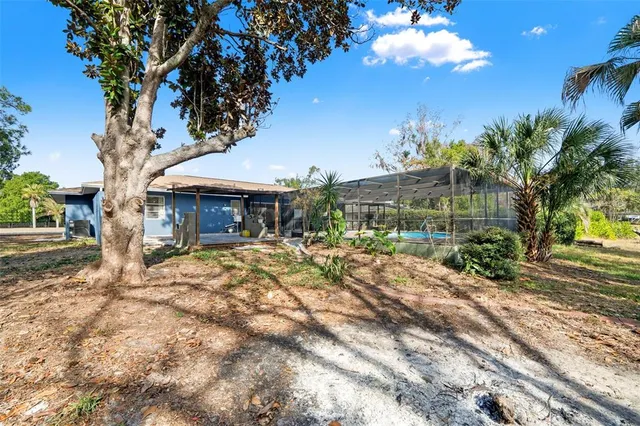 a view of a house with garden and sitting area