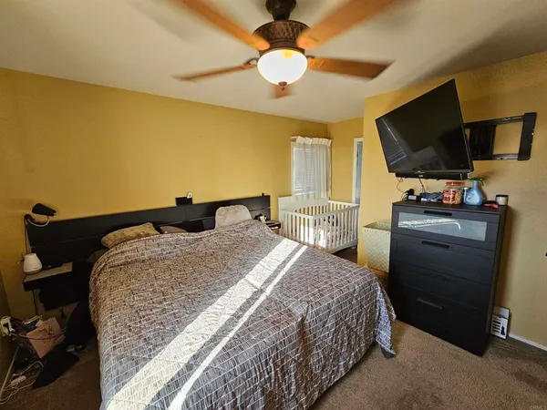 a bedroom with a bed and flat screen tv