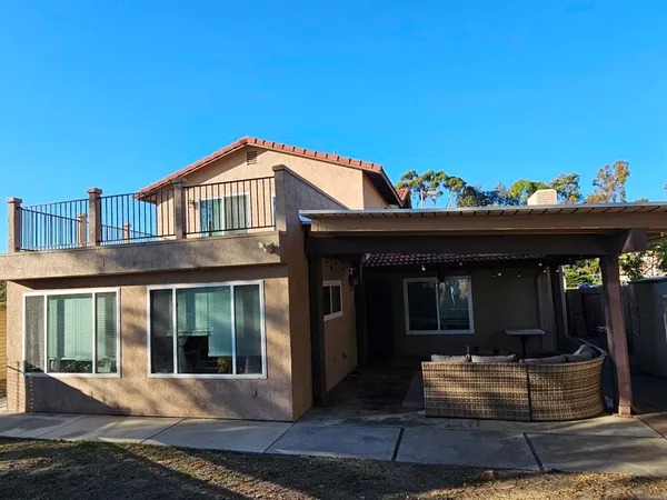 a view of a house with entrance stairs and a table