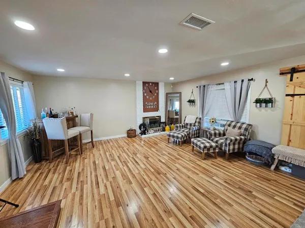 a bedroom with furniture and a wooden floor