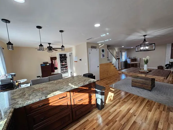 a living room with lots of furniture and kitchen view
