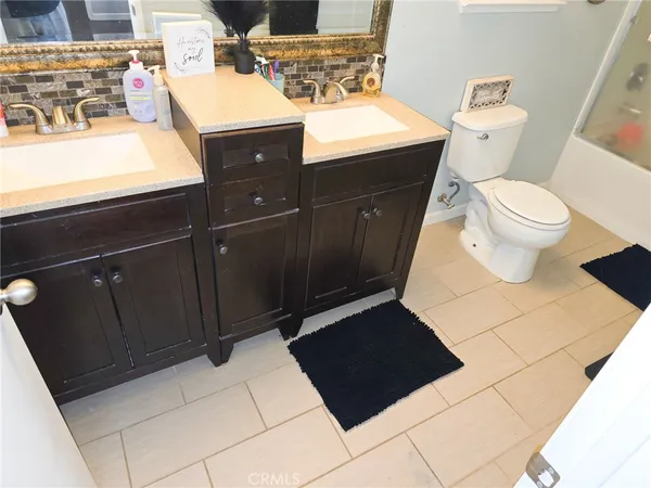 a bathroom with a sink a toilet and mirror