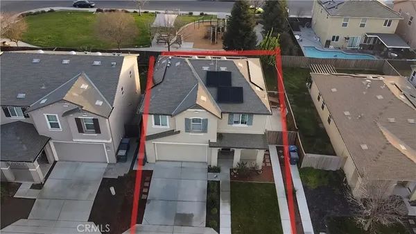 an aerial view of a house with a yard