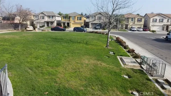 a city view with tall buildings and a yard