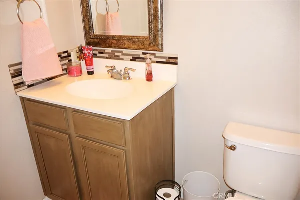 a bathroom with a sink a toilet and mirror