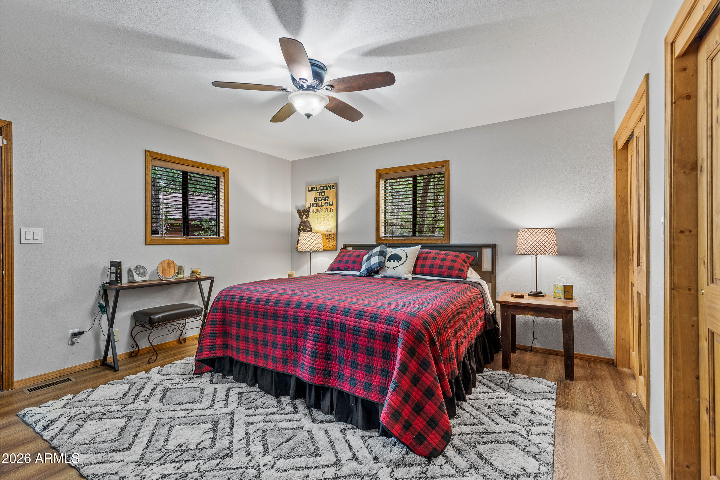 755 East Meadow View Road Munds Park, AZ 86017 - Photo 28 of 35 a bedroom with a bed and a chandelier