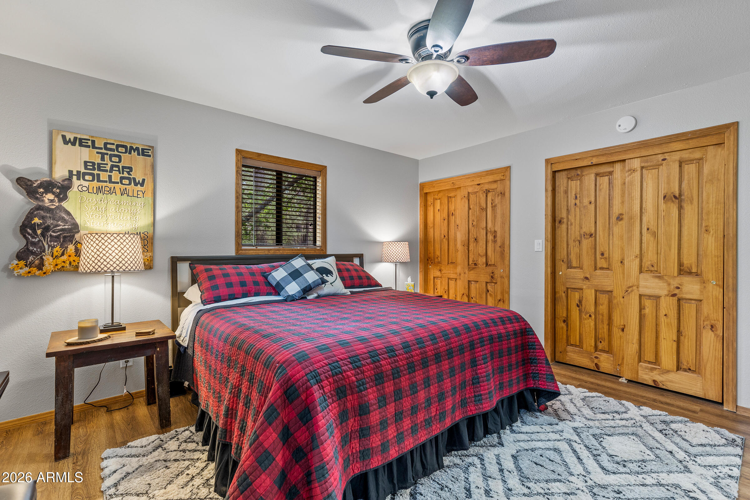 755 East Meadow View Road Munds Park, AZ 86017 - Photo 30 of 35 a bedroom with a bed and wooden floor