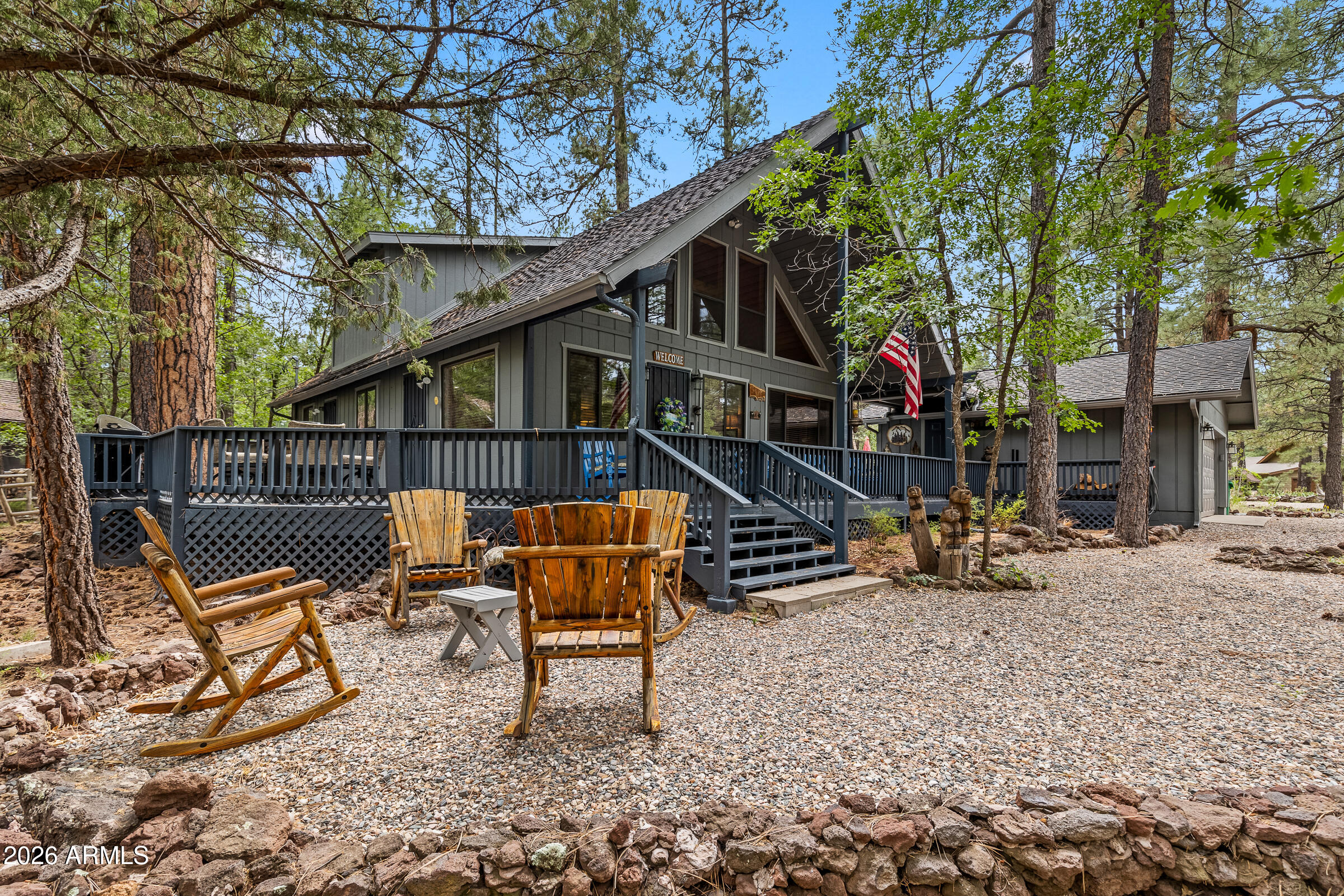 755 East Meadow View Road Munds Park, AZ 86017 - Photo 3 of 35 a backyard of a house with table and chairs