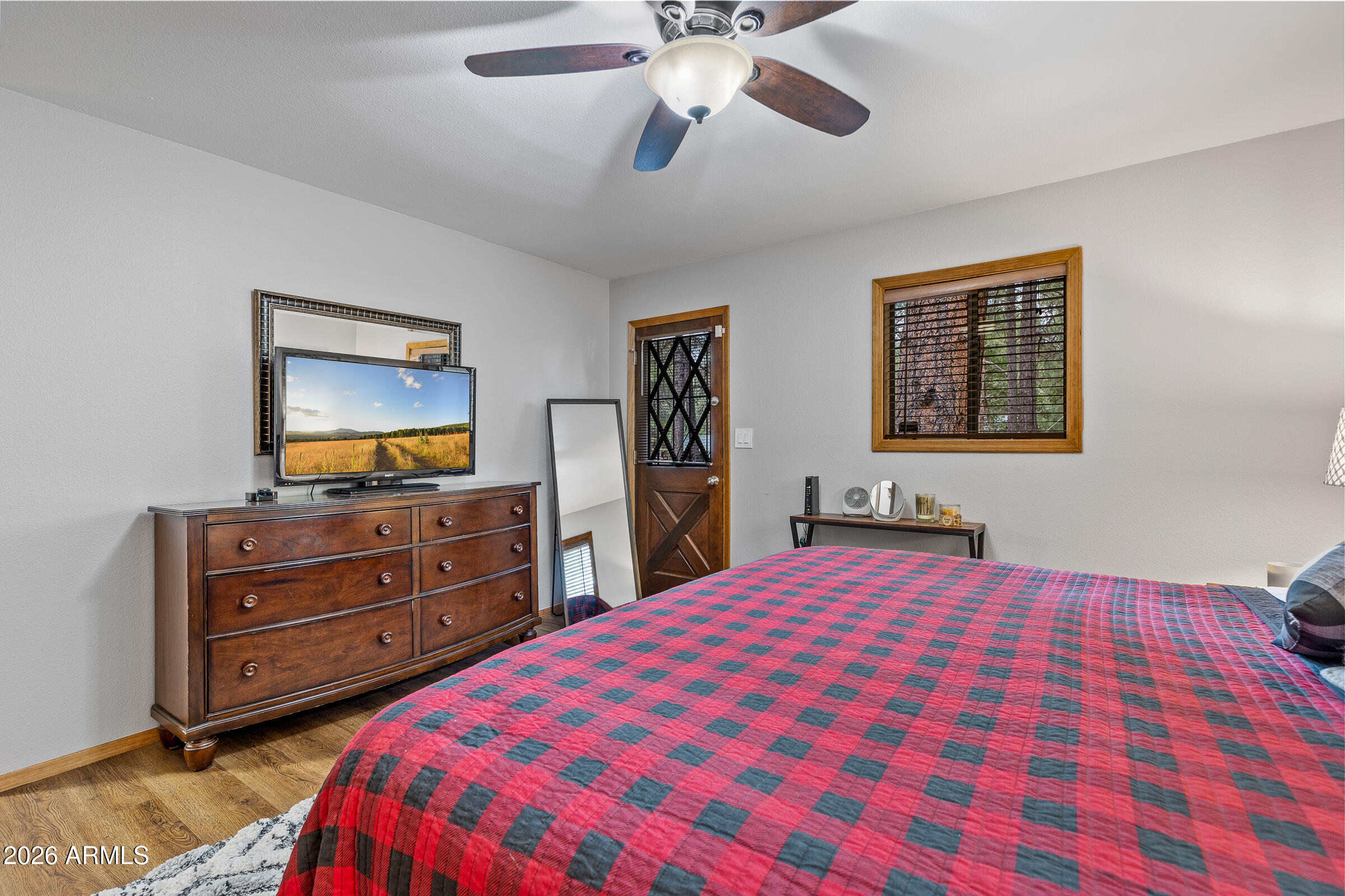755 East Meadow View Road Munds Park, AZ 86017 - Photo 31 of 35 a bedroom with a bed and a dresser