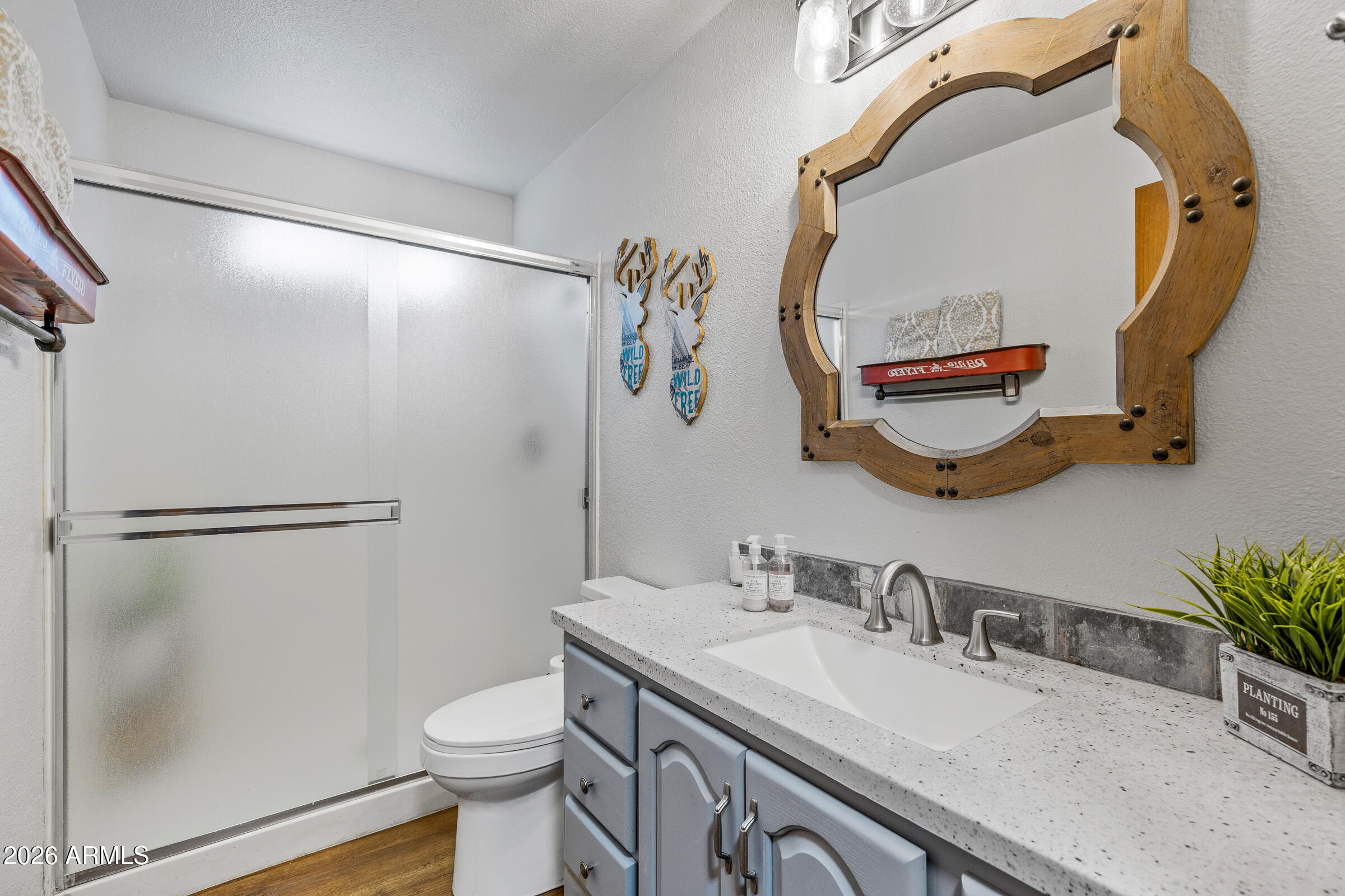 755 East Meadow View Road Munds Park, AZ 86017 - Photo 35 of 35 a bathroom with a granite countertop sink mirror vanity and toilet
