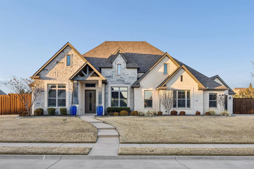 2121 Weathertop Lane Prosper, TX 75078 - Photo 1 of 1 a view of a white house with large windows and a yard