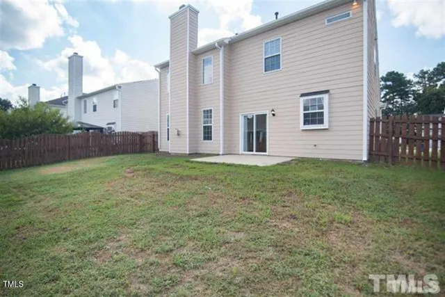 a view of a house with a yard and garage