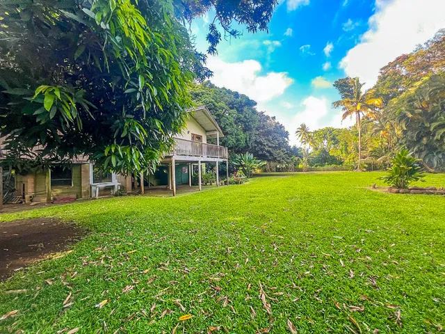 a view of house with yard and entertaining space