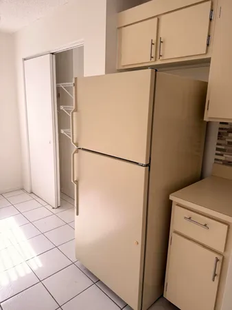a close view of stove top oven with dishwasher and white cabinets